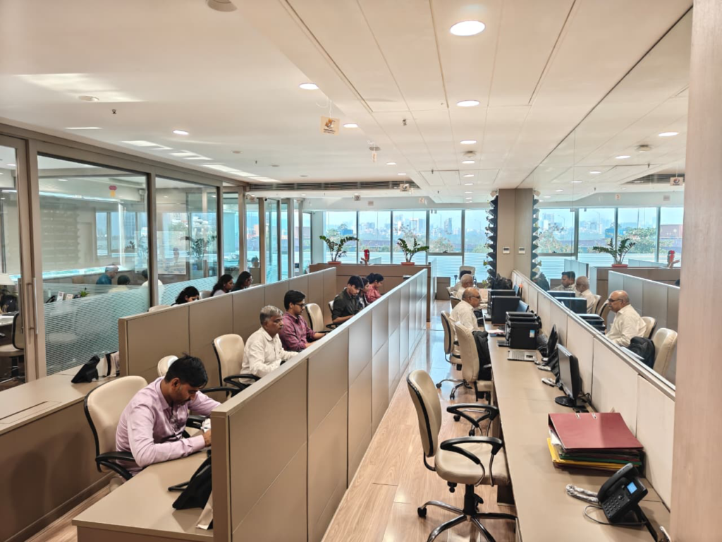 Staff working at desks in an open-plan office.